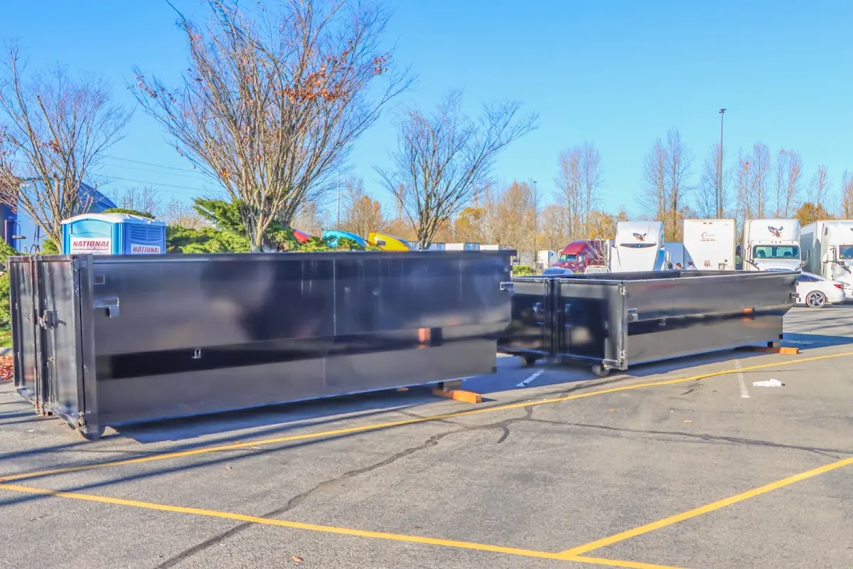 Professional dumpster rental service with roll-off container on residential driveway in Clute